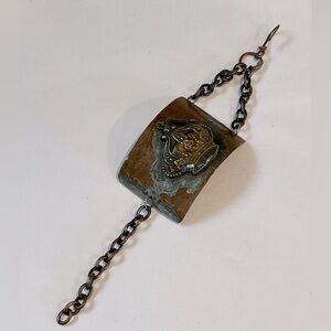 Cuff-like bracelet with chain closure. Costume jewelry. 8” length.